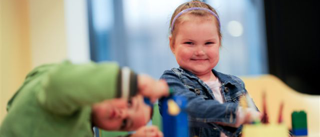 Children building blocks and playing together